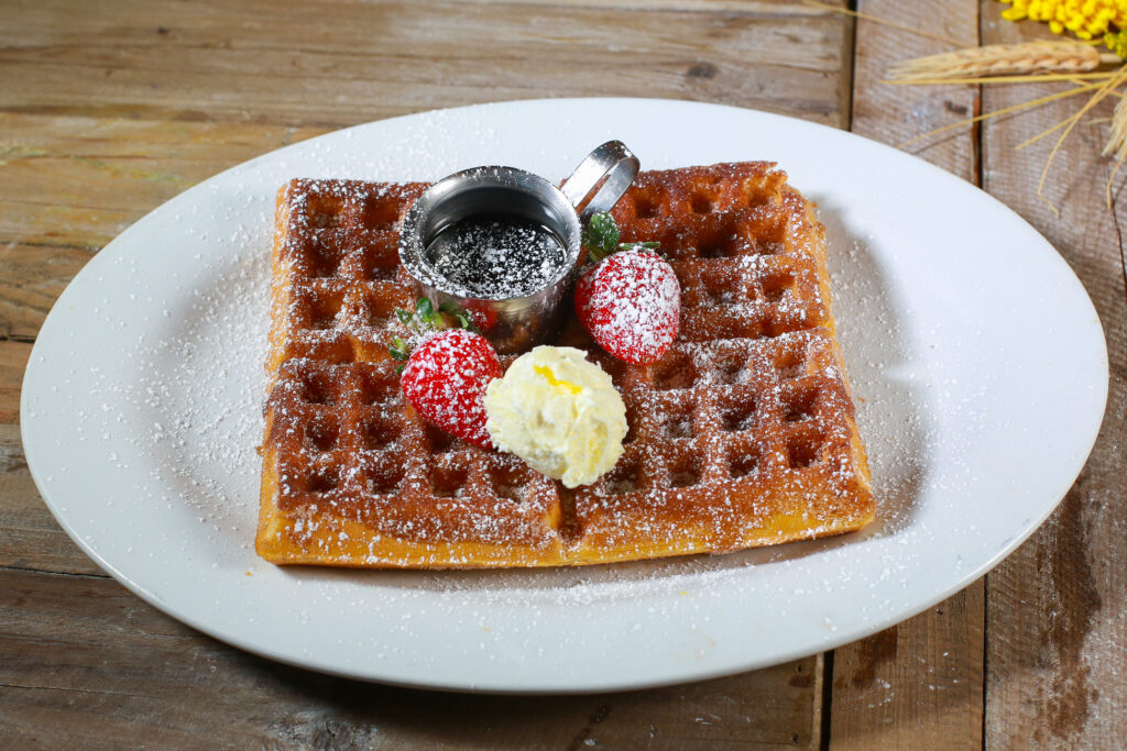 How Hash House A Go Go at The Flamingo Elevates Comfort Food 1 Banana pecan French toast in full spring bloom with whipped butter, maple syrup, and orange slices at Hash House A Go Go