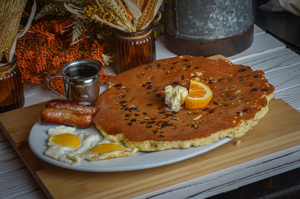 Brunch Places Near Me: 7 Reasons To Discover Hash House A Go Go in Winter Garden 1 Oversized chocolate chip pancake with eggs and sausage at Hash House A Go Go