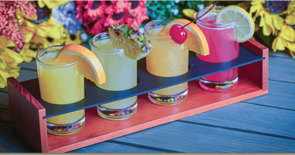 Colorful mimosa flight with orange, pineapple, guava, and strawberry lemonade served at Hash House a Go Go Flamingo Crossings
