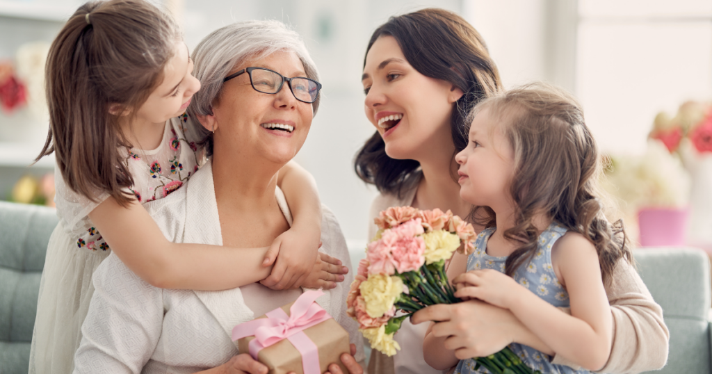 Family celebrating Mother’s Day with flowers and gifts, highlighting Hash House A Go Go at Flamingo Crossings as a festive choice for Mother’s Day brunch in Winter Garden.